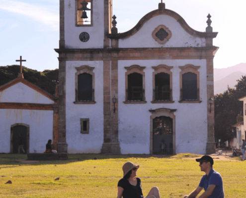 Husband and wife relaxing in front of a church ~ MarriageHeat