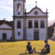 Husband and wife relaxing in front of a church ~ MarriageHeat