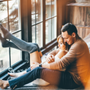 Husband and wife enjoying a winter cuddle in a cabin retreat - MarriageHeat