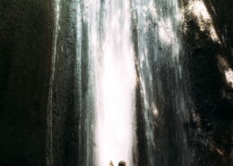 Man and wife sensually embracing in front of a waterfall ~ MarriageHeat